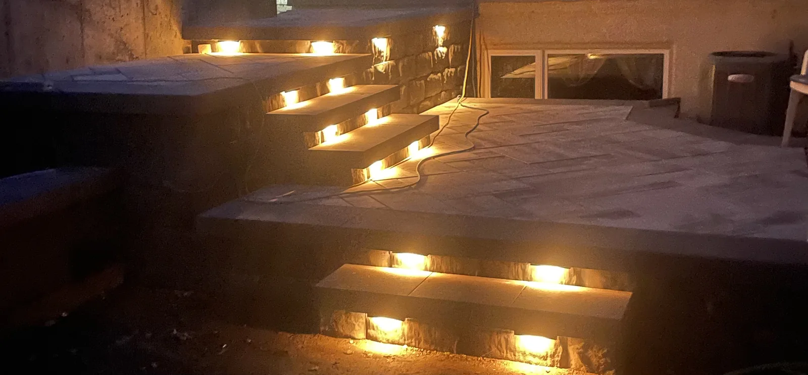 Warm step lights on floating stairs at night