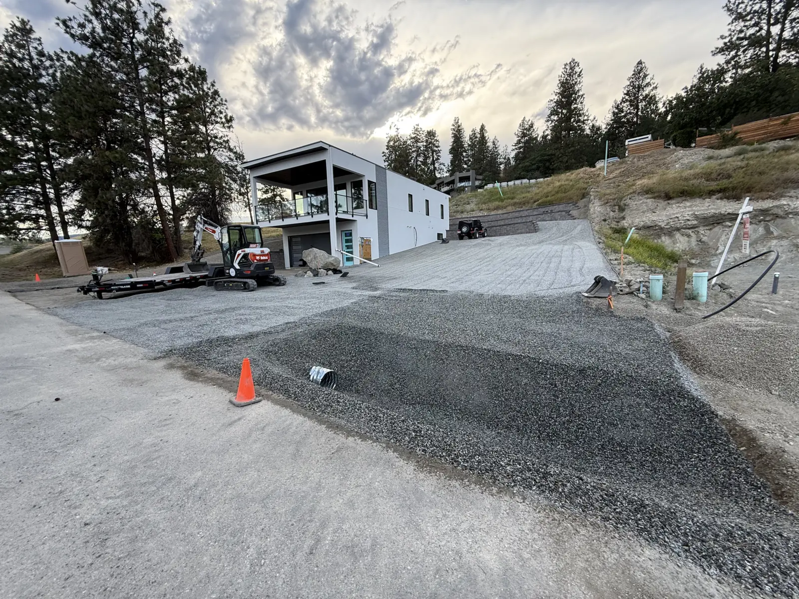 Gravel base graded for a new driveway beside a new home