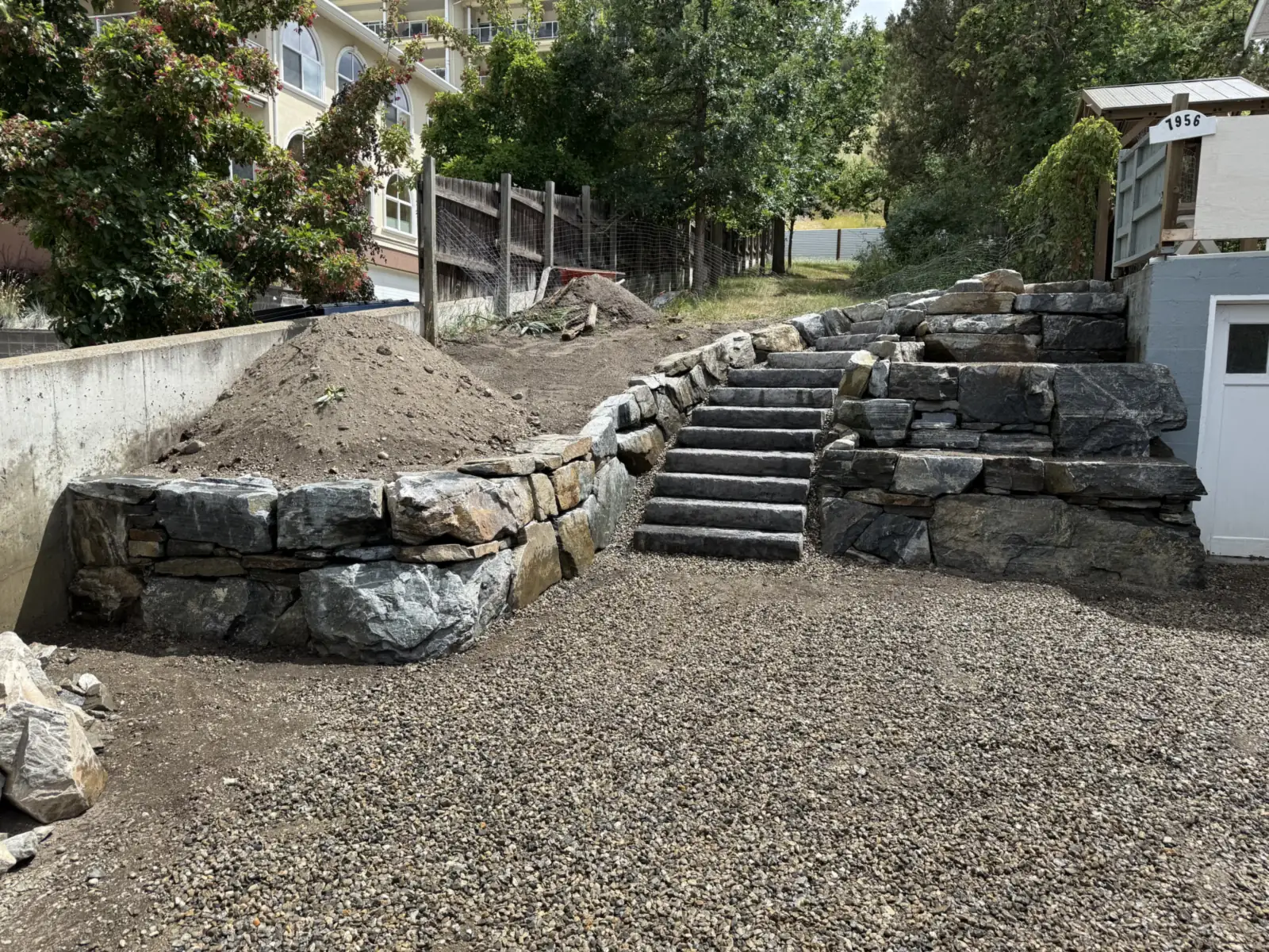 Terraced natural stone retaining walls with a cut stone staircase