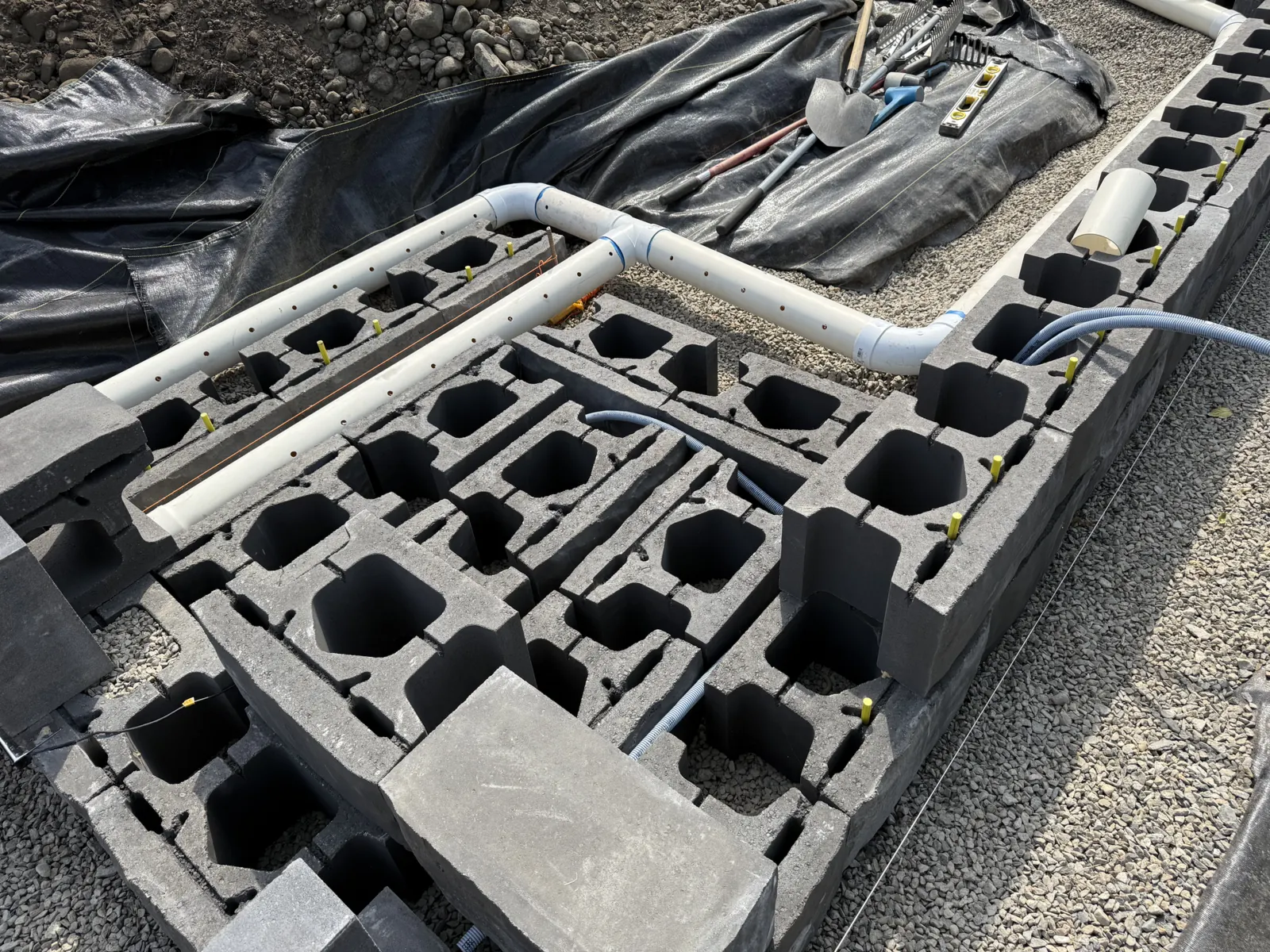 Pipe runs set through the cores of a block wall before fill