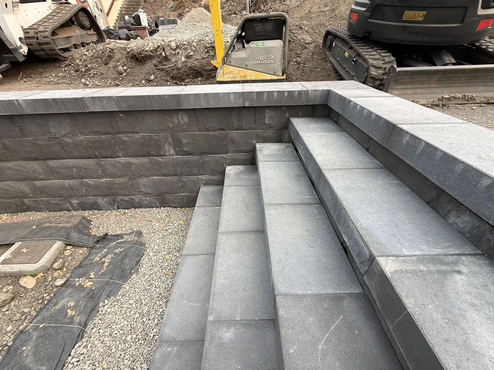 Block steps set into a capped retaining wall