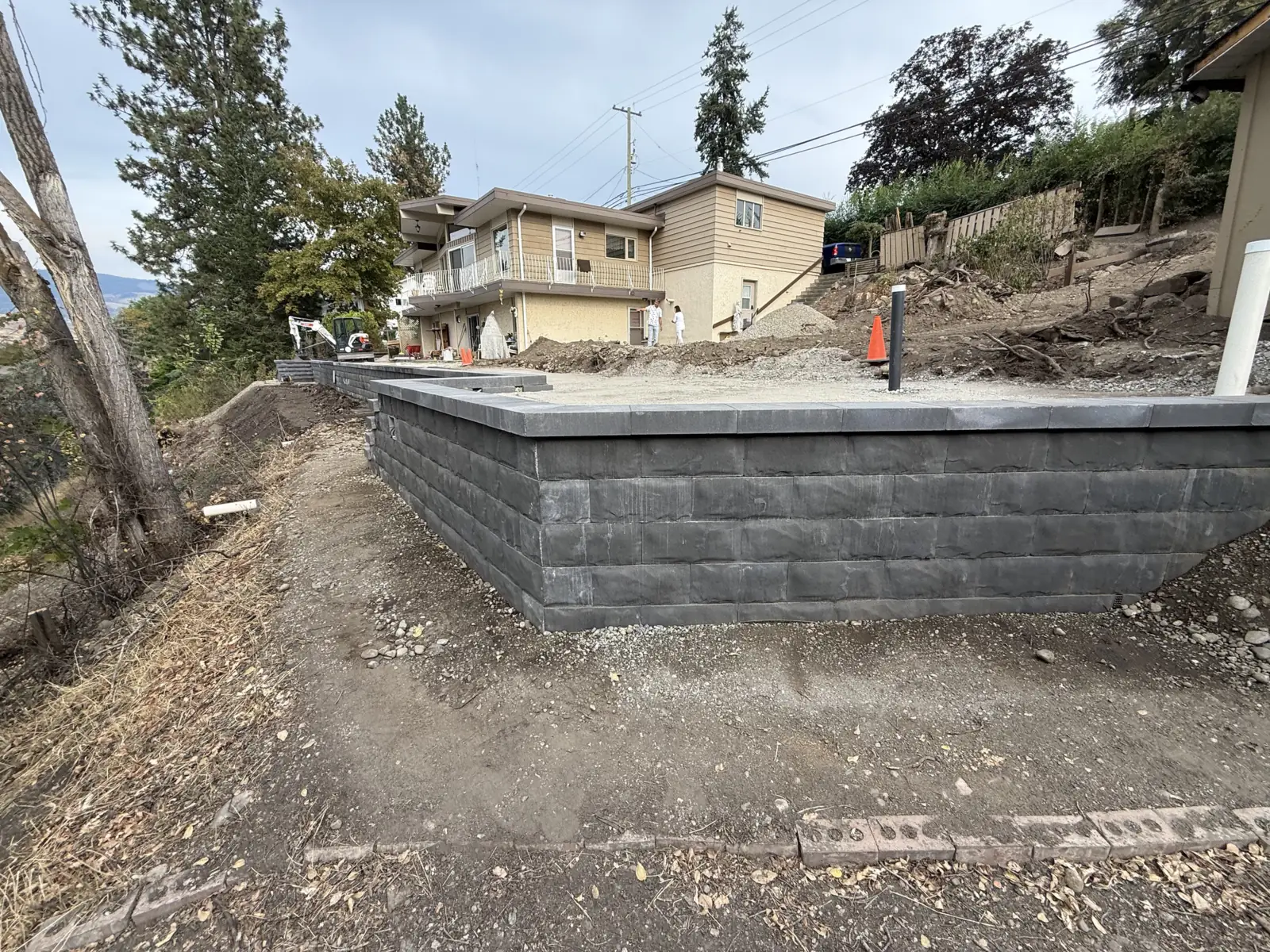 Capped block retaining wall built up to a new yard level
