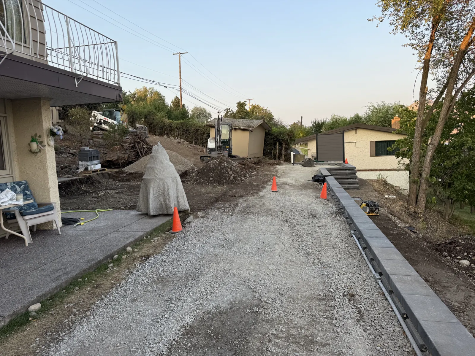Gravel base for a new drive along a capped block wall