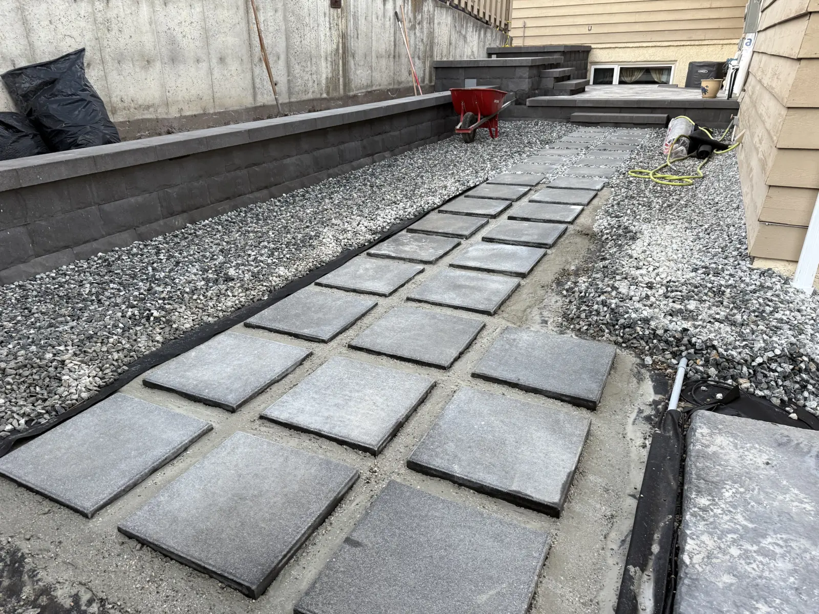 Stepping stone slabs being set in the side yard