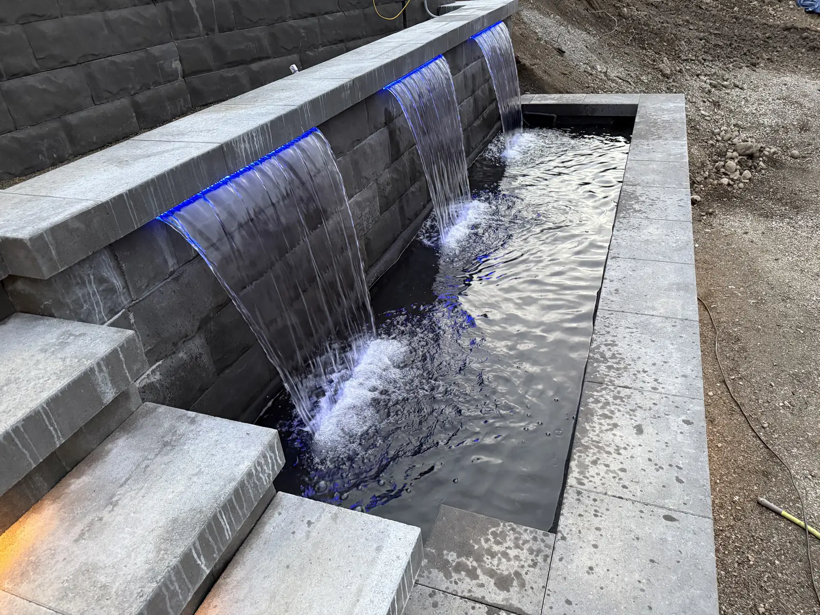 Water feature running for the first time, blue lights under the spillways