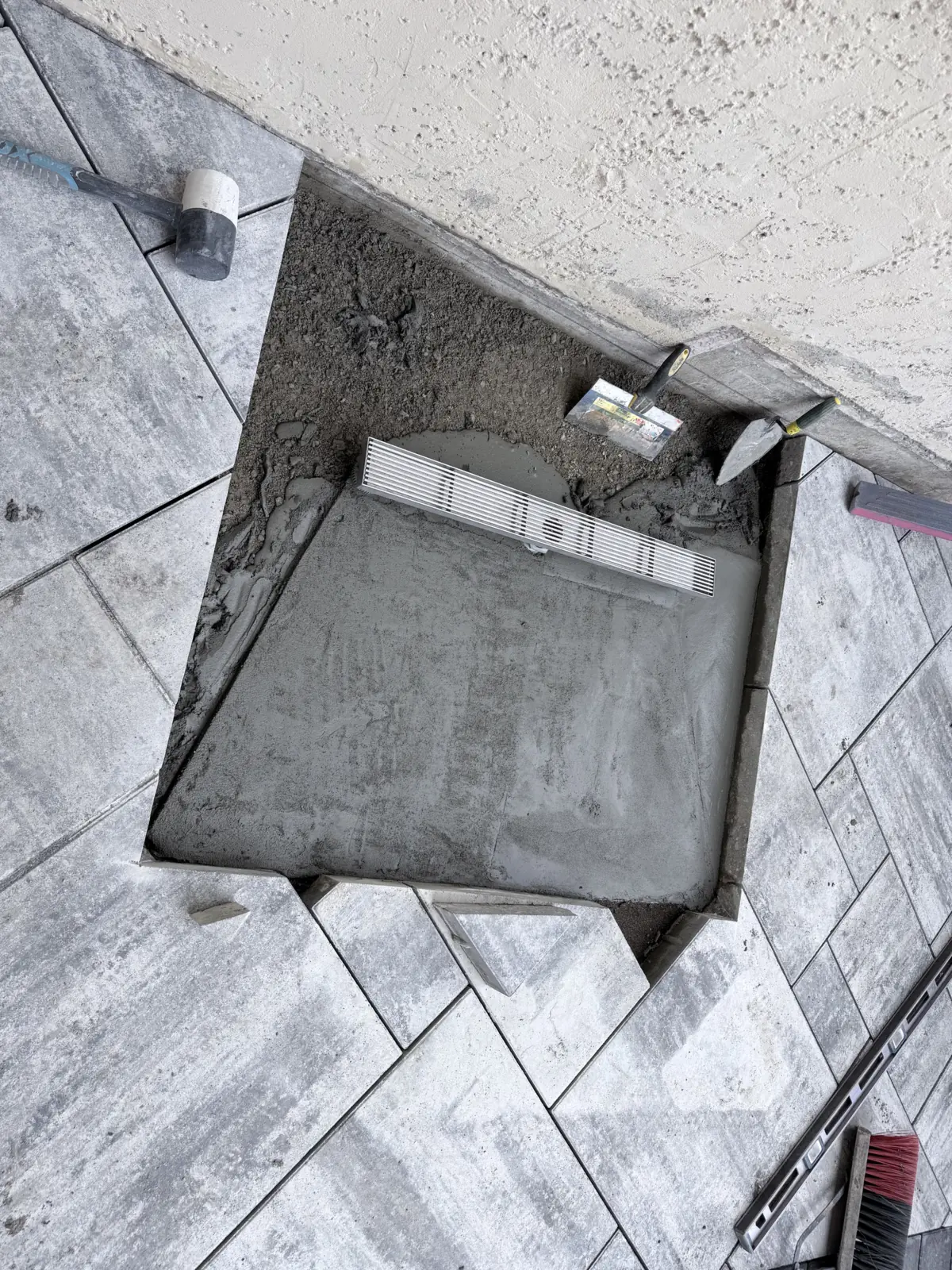 Cleanout box set in mortar inside a large format paver patio