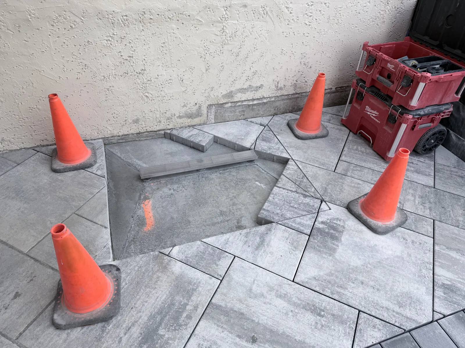 Paver pattern cut open around a cleanout before the inlay is set