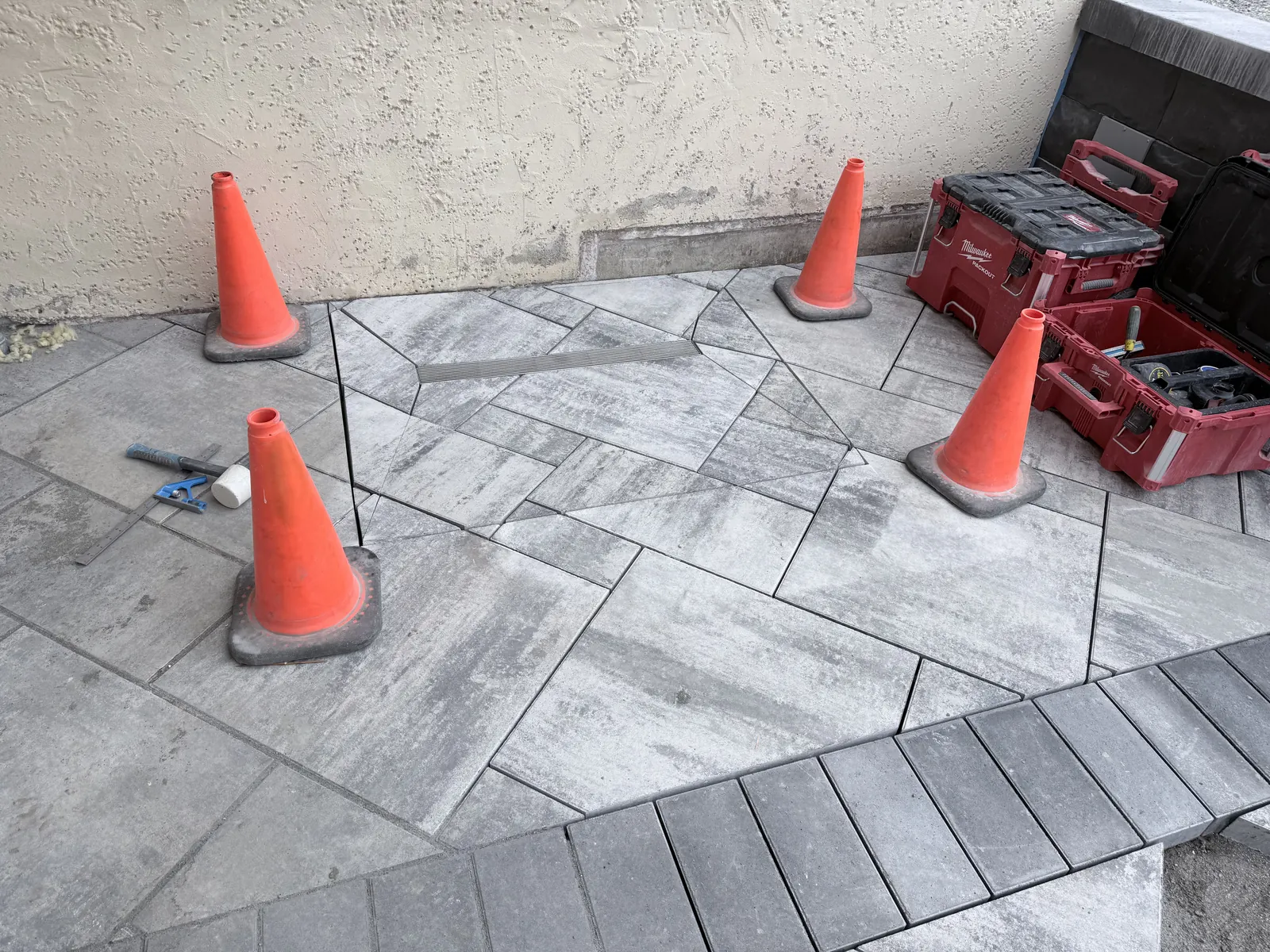Finished paver inlay cut around a cleanout to match the pattern