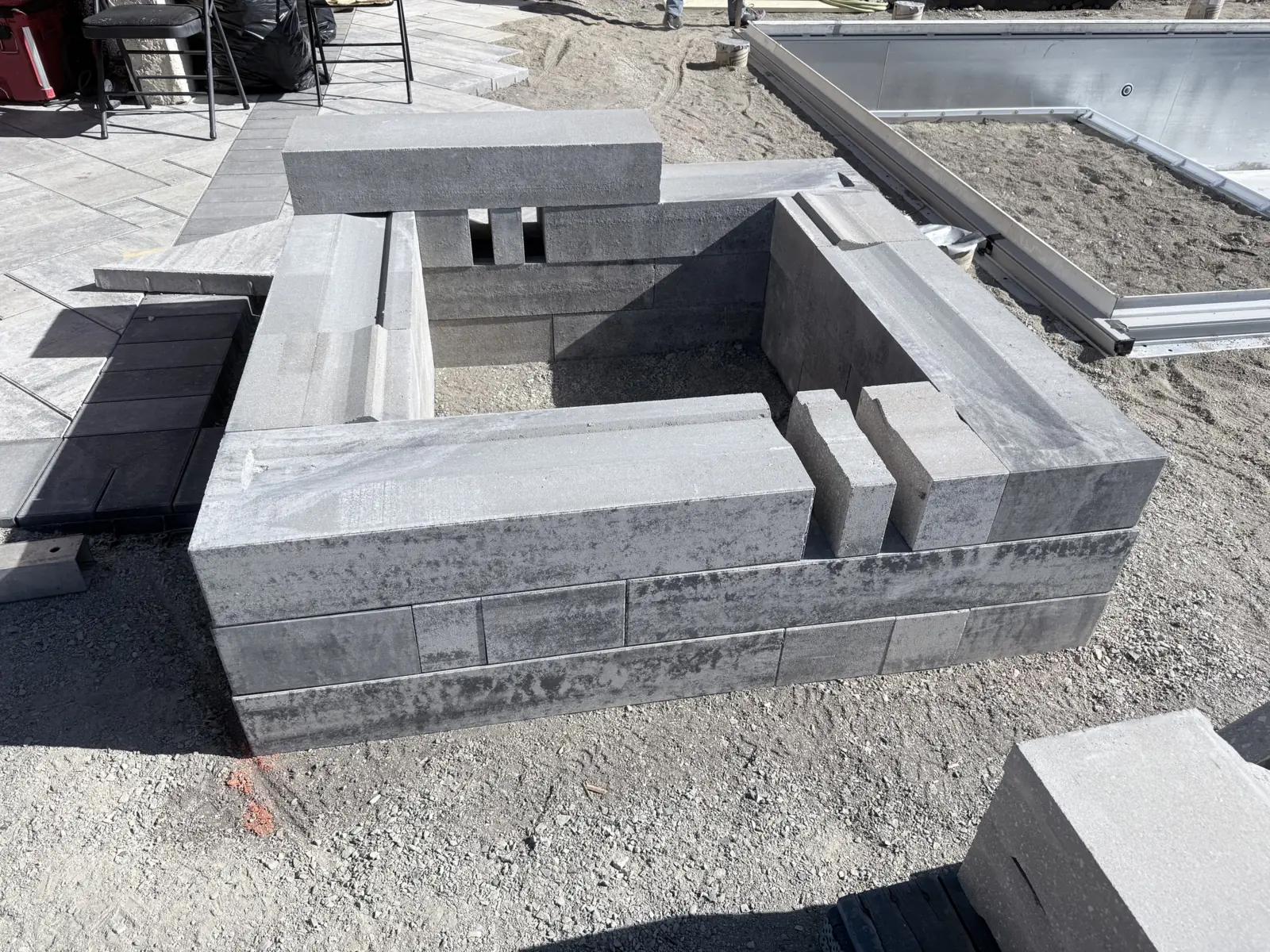 Block fire feature being built on the paver deck